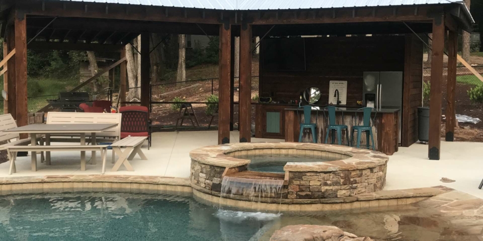 Beautiful turquoise pool with outdoor bar and seating area