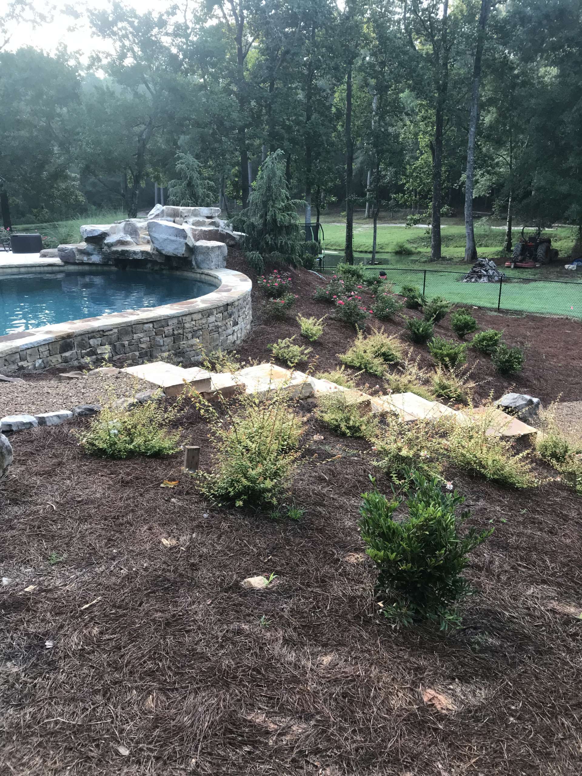 Stone stairs leading up a hill to a pool